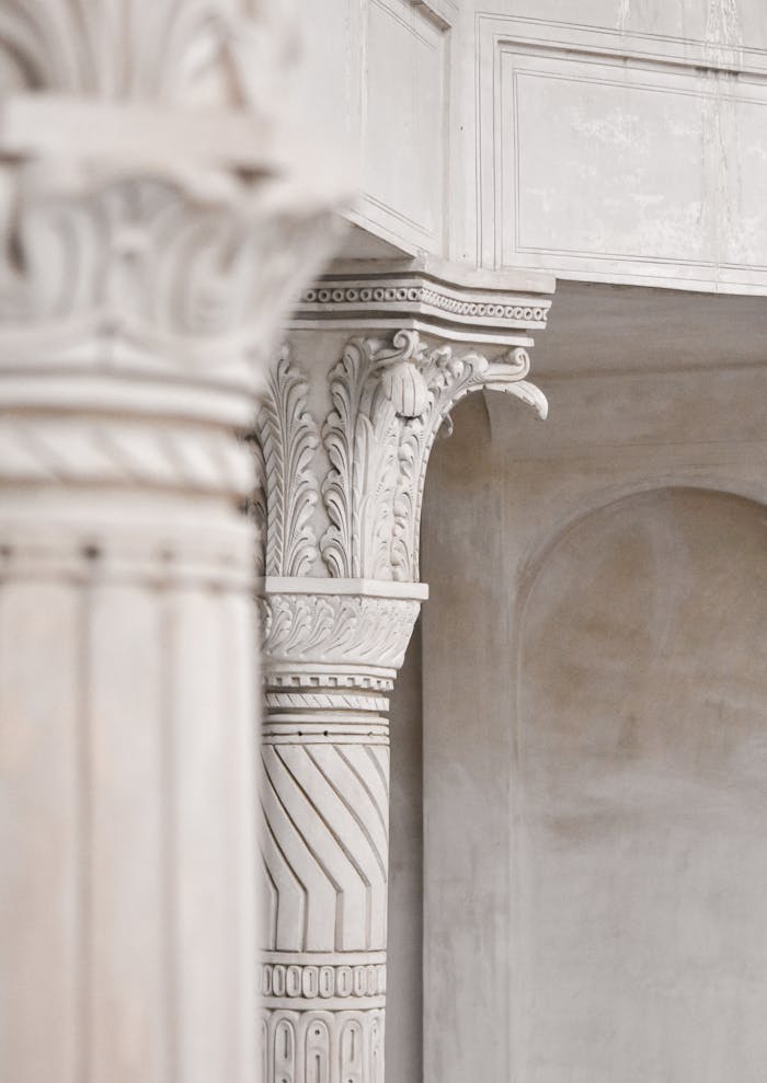 about-02 Elegant marble columns demonstrating classic architectural details with ornate carvings.