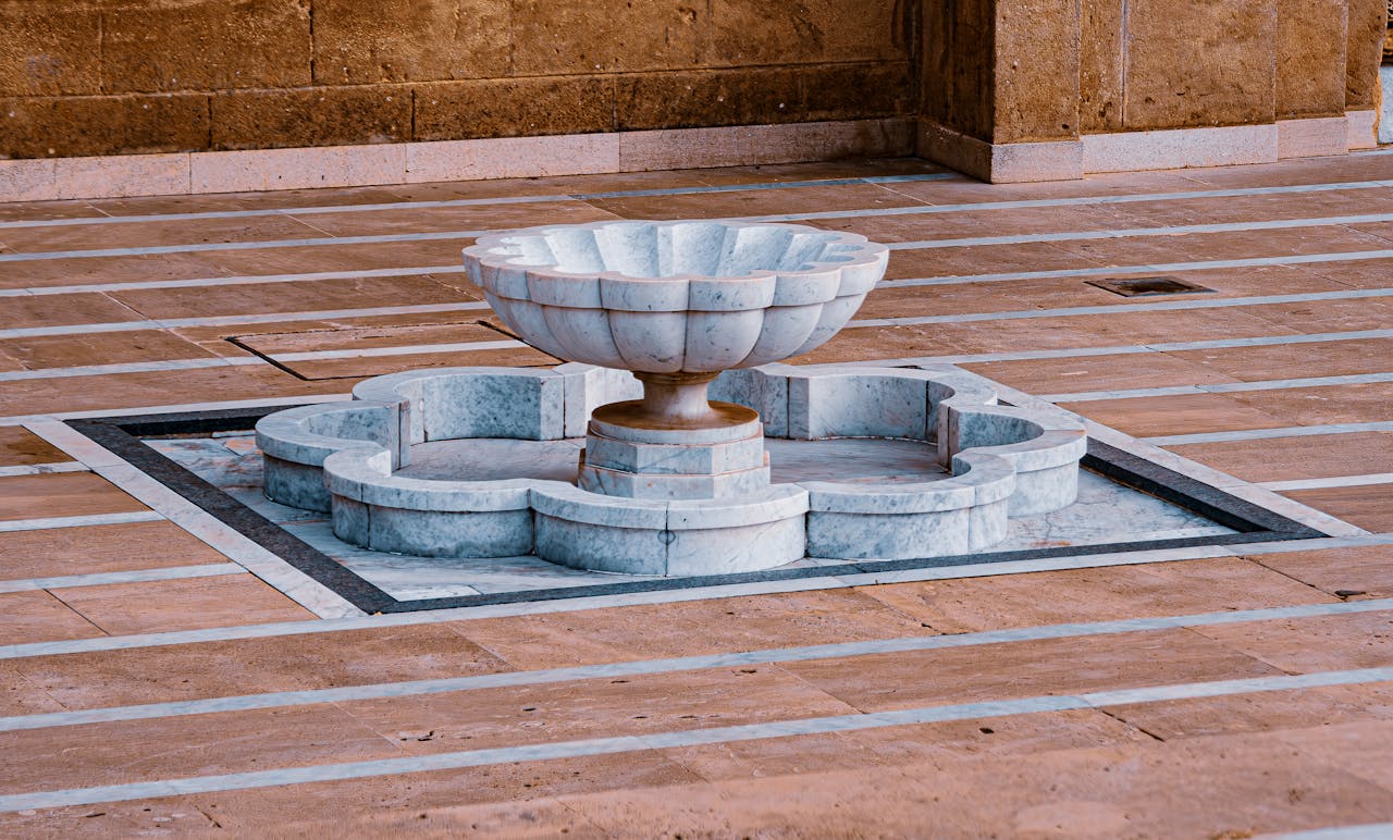 services-04 Intricately designed marble fountain in a Moroccan courtyard, showcasing artistic elegance.