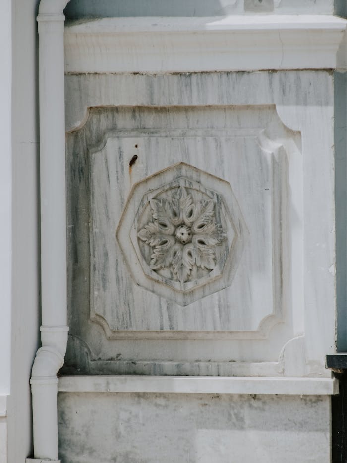 services-03 Intricate stone carving on a building facade showcasing architectural design.
